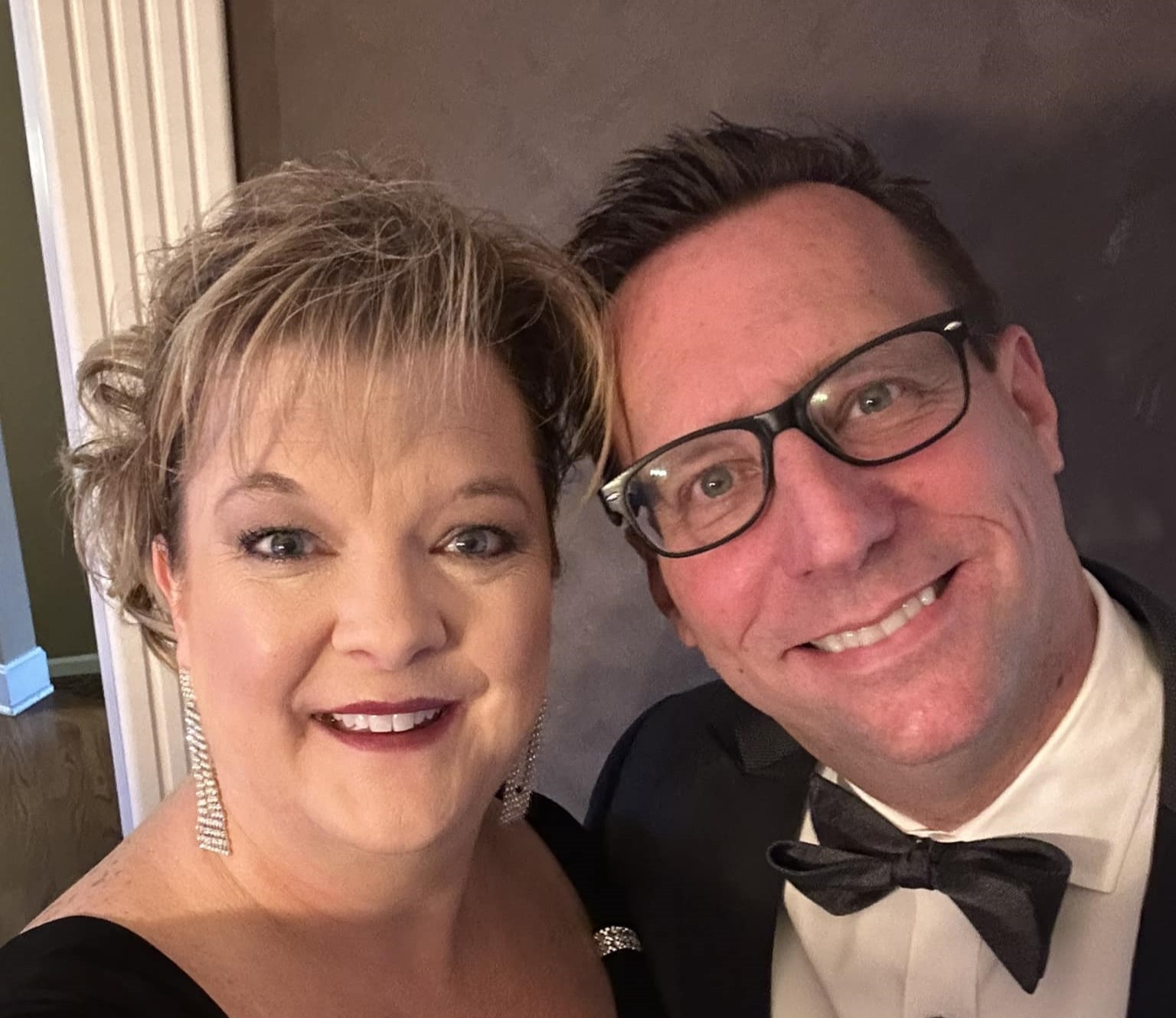 Tammy and Chad Butterfield dressed up and smiling at an awards event.