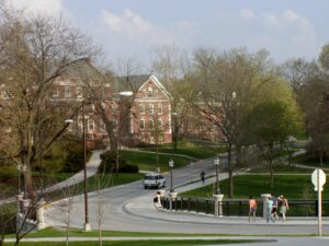 A view of Roberts Residence Hall on Iowa State University campus nestled among trees.